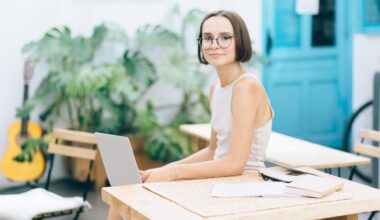 Woman in White Dress Wearing Eyeglasses Holding Laptop on Her Knees