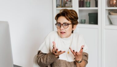 Confident female employee having video chat on computer in workspace