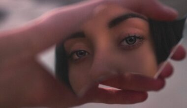 Shallow Focus Photo of Woman's Reflection on Broken Mirror