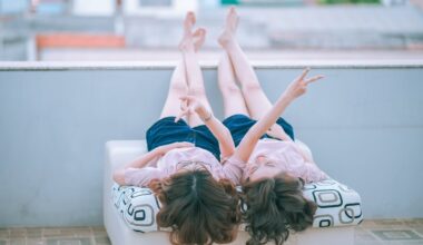 Two women lying on a white mattress