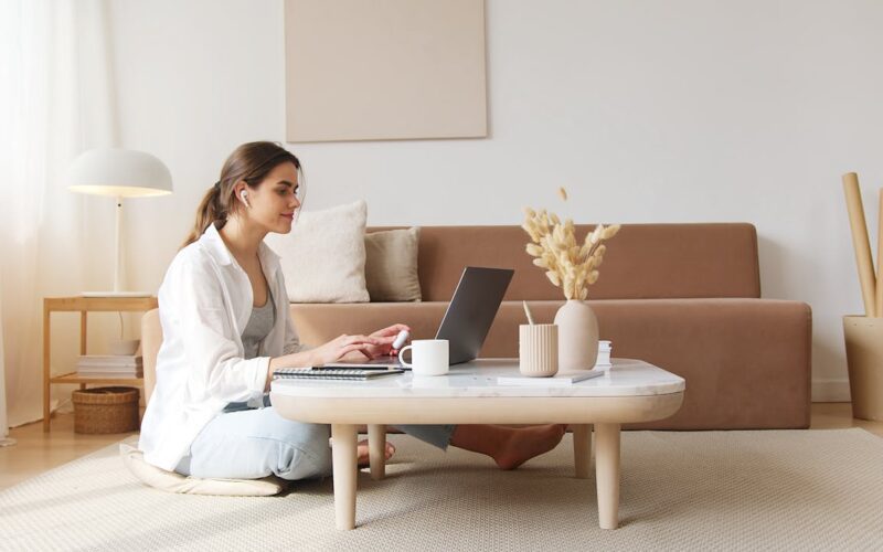 Content woman using laptop on floor