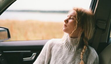 Woman in Sweater Sitting Inside a Car