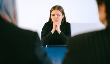 Woman in Black Blazer Sitting Being Interviewed