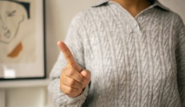 woman pointing finger in light room