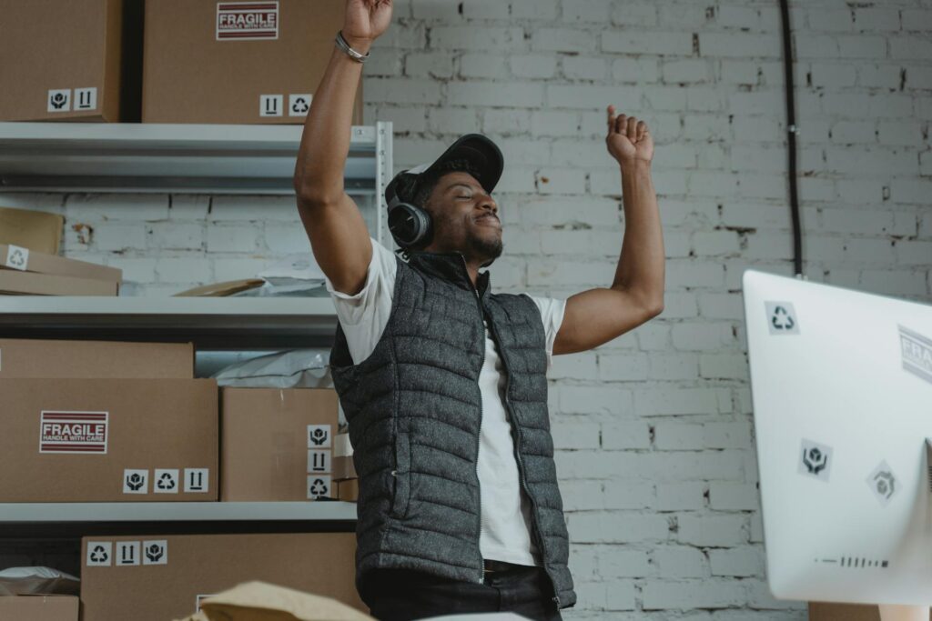 Guy Grooving at Work Wearing a Grey Vest