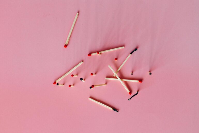 Wooden Matchsticks on the Pink Surface