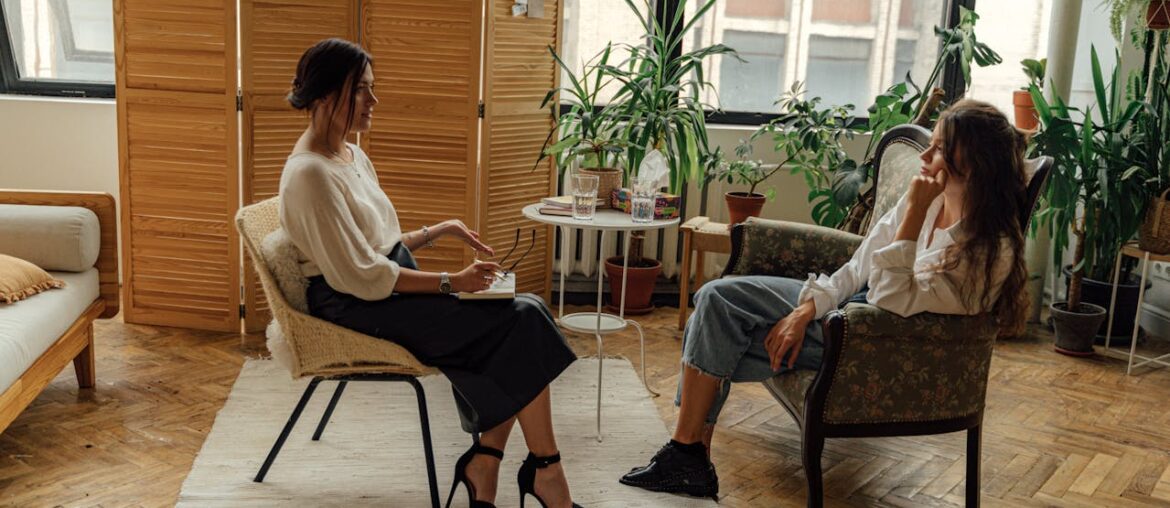 Woman in White Shirt Sitting on Chair