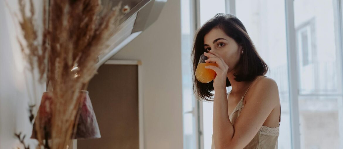 A Woman Drinking a Beverage from a Glass