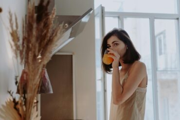 A Woman Drinking a Beverage from a Glass