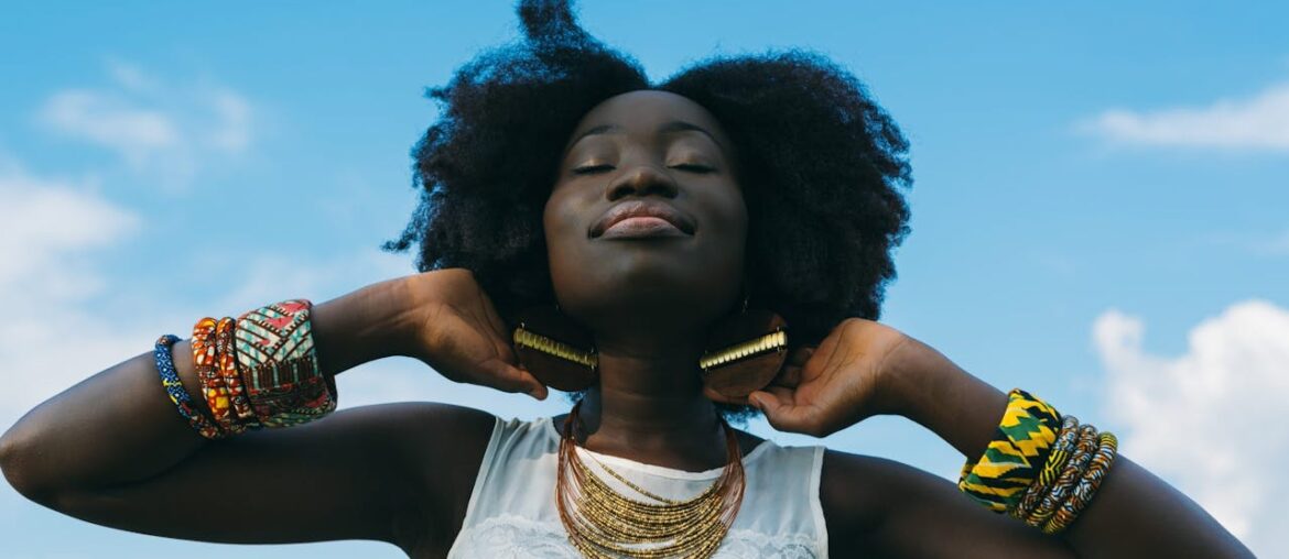 A woman standing outside with her eyes closed