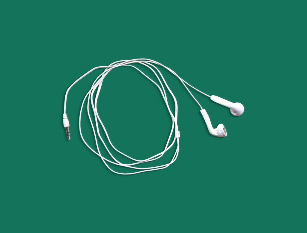 White Earphones on Green Background