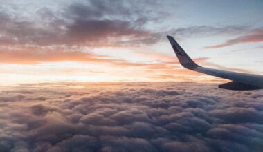 White Airliner Wing on Top of Sea Clouds