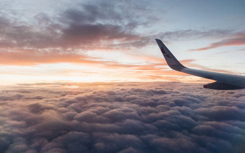 White Airliner Wing on Top of Sea Clouds