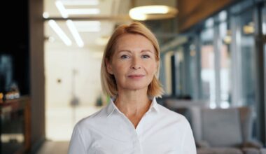 A therapist in a white shirt standing in an indoor space