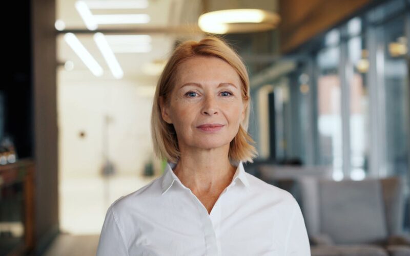 A therapist in a white shirt standing in an indoor space