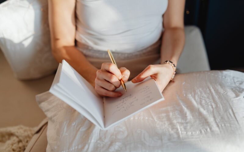Woman Writing in a Dream Diary Notebook