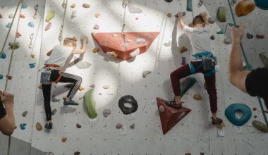 Young Man and Girl Climbing on A Rock Wall