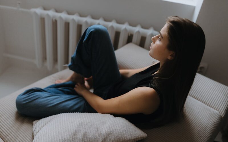 Woman Sitting alone on a Sofa