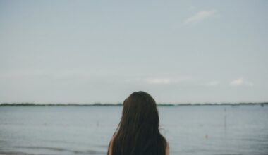 Woman Standing Near Body of Water during Daytime