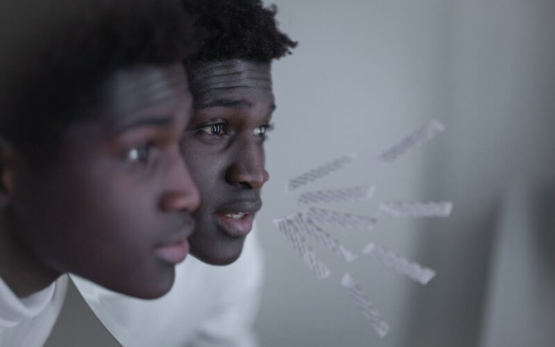 Man Standing Close to Mirror While Speaking