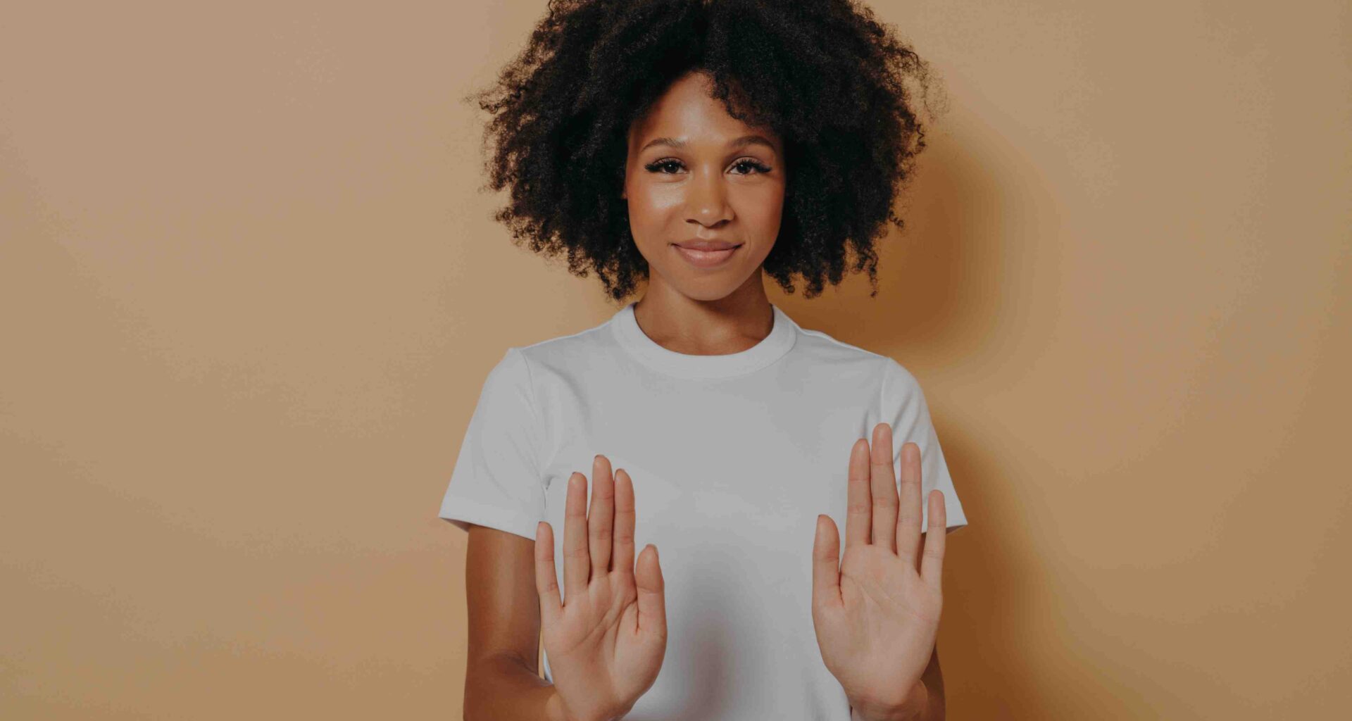 Woman holding her hands out signalling "no"