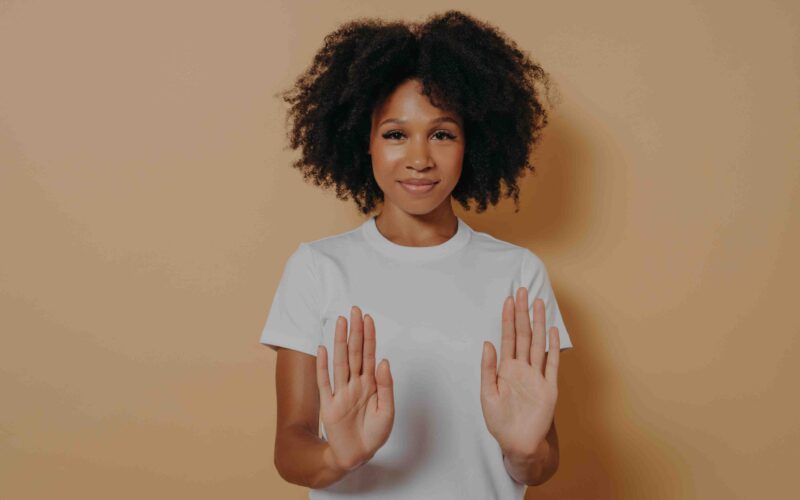 Woman holding her hands out signalling "no"