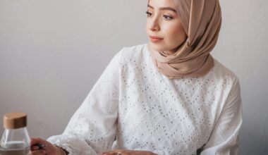 Professional woman wearing hijab at her desk.