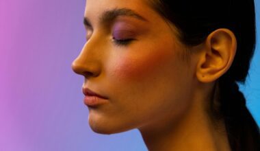 Deeply focused woman closing her eyes against a multicolour background