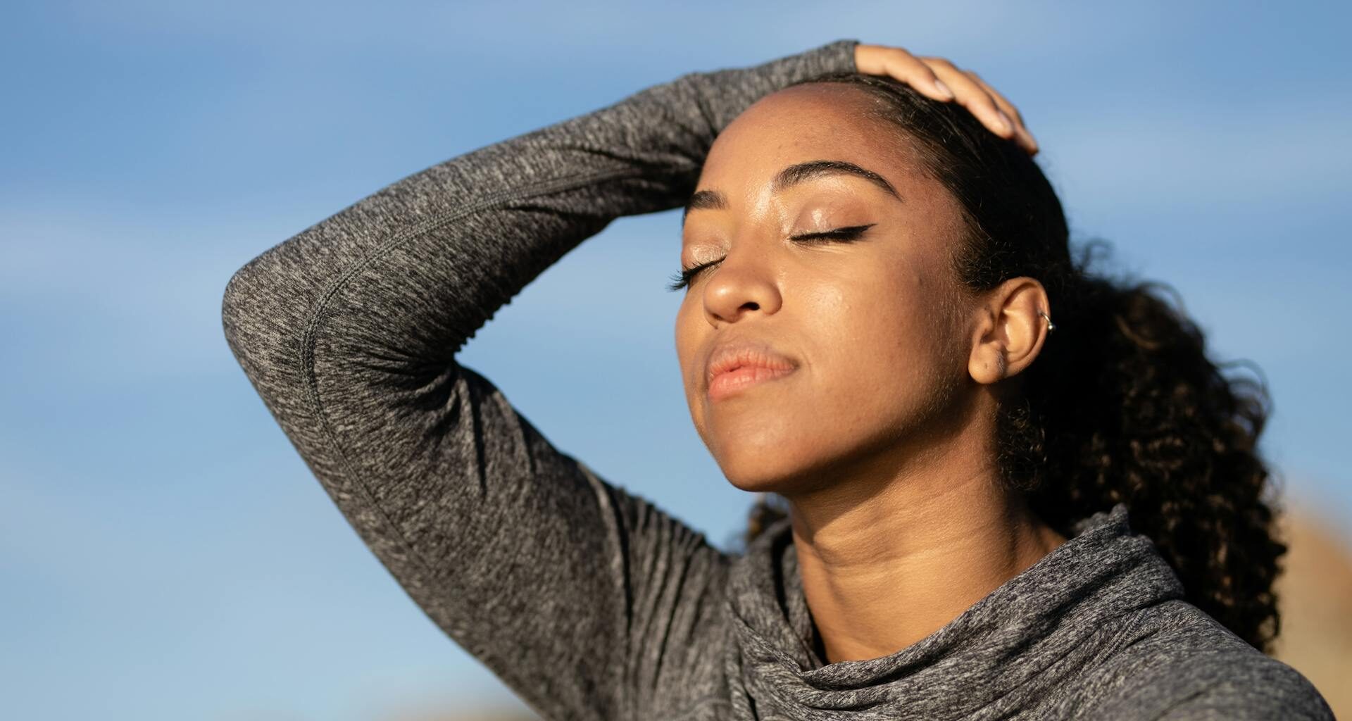 Woman practicing calm self-regulation, eyes closed in a moment of stillness