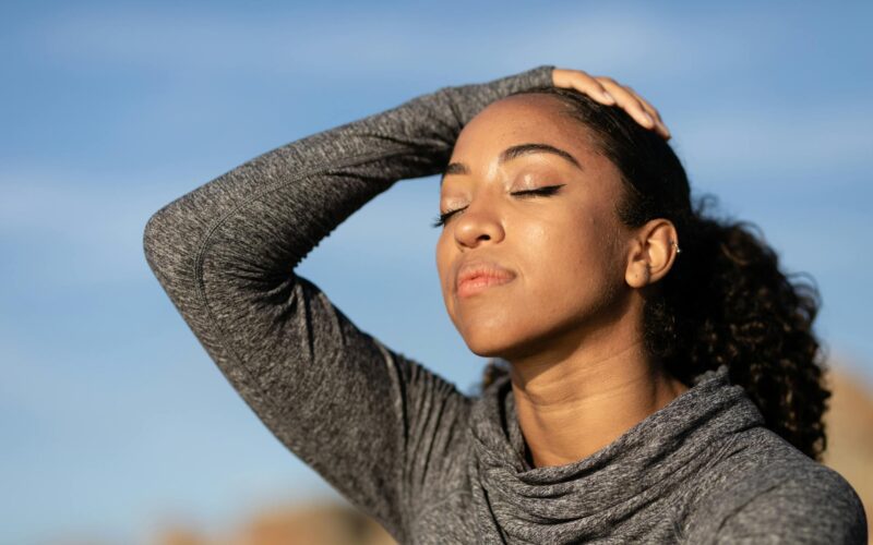 Woman practicing calm self-regulation, eyes closed in a moment of stillness