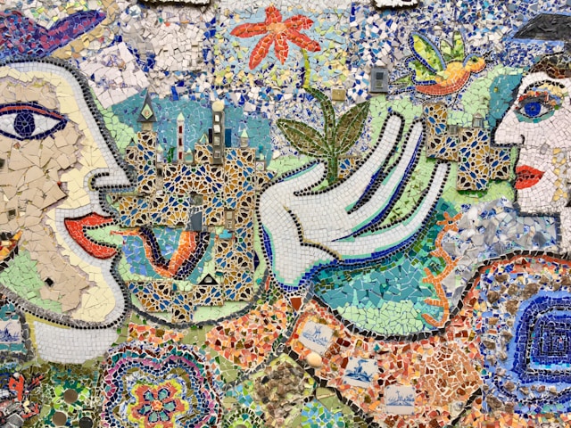 Two faces in a colourful mosiac