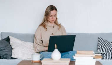 Serious woman searching for therapist with laptop at home