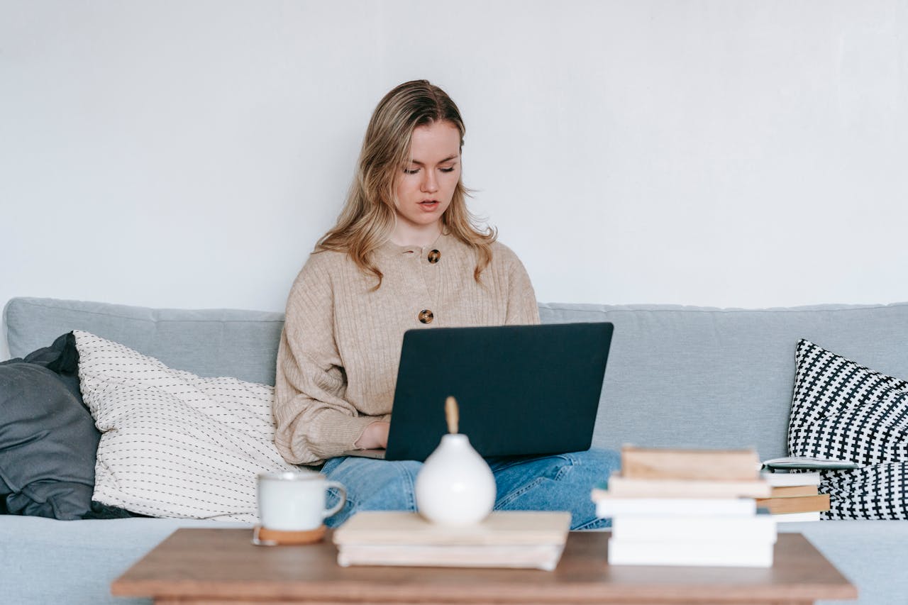 Serious woman searching for therapist with laptop at home
