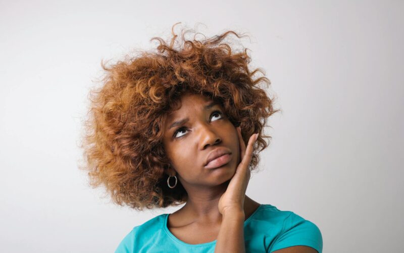Woman in Blue Crew Neck Shirt Pondering a Decision