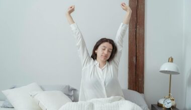 Sleepy woman waking up on bed in morning