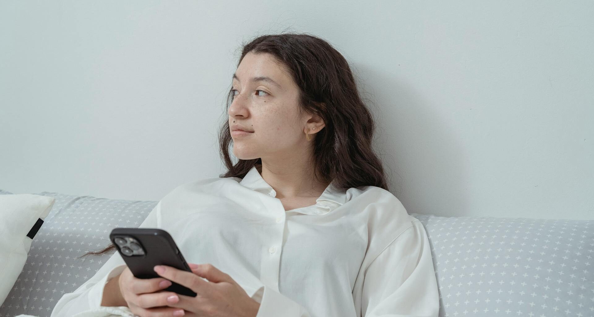Woman Sitting with Cellphone