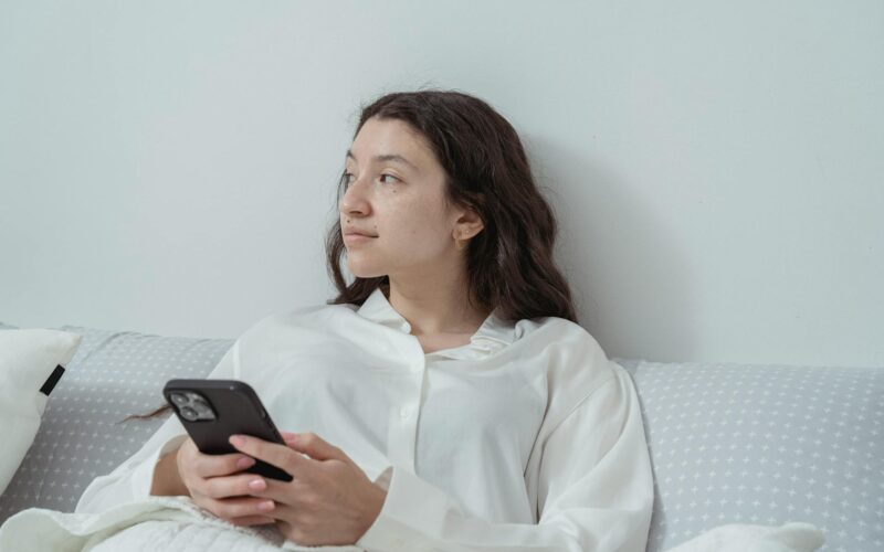 Woman Sitting with Cellphone