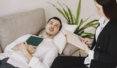 A focused therapist listens to a patient during a psychotherapy session
