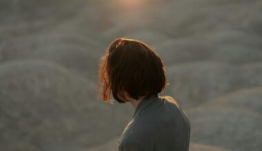 Contemplative moment captured in a desert landscape with a person in a suit at sunset
